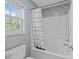 Cozy bathroom featuring a shower/tub combo and a window with natural light at 5240 Holly Ridge Farm Rd, Raleigh, NC 27616