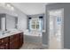 Relaxing bathroom featuring a soaking tub, a window, and a vanity with ample storage at 5240 Holly Ridge Farm Rd, Raleigh, NC 27616