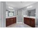 Large bathroom features a stand up shower, dual sinks, mirrors, and cherry wood cabinets at 5240 Holly Ridge Farm Rd, Raleigh, NC 27616