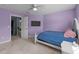 Cozy bedroom with a soft carpet, a ceiling fan, and a large window for natural light at 5240 Holly Ridge Farm Rd, Raleigh, NC 27616