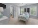This bedroom features a whimsical 4-poster bed, large windows, and neutral paint at 5240 Holly Ridge Farm Rd, Raleigh, NC 27616