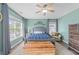 Bright and airy bedroom features large windows, wood floors, and a cozy sitting area at 5240 Holly Ridge Farm Rd, Raleigh, NC 27616