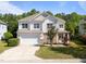 Charming two-story home with stone accents, attached two-car garage, and manicured landscaping at 5240 Holly Ridge Farm Rd, Raleigh, NC 27616