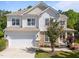 Beautiful two-story home with stone accents, a front porch, and meticulously maintained landscaping at 5240 Holly Ridge Farm Rd, Raleigh, NC 27616
