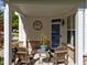 Inviting front porch with seating, decorative plants, and a stylish entrance door at 5240 Holly Ridge Farm Rd, Raleigh, NC 27616