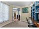 Comfortable home office featuring custom built-in shelving and adjacent rooms at 5240 Holly Ridge Farm Rd, Raleigh, NC 27616