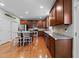 Spacious kitchen featuring hardwood floors, stainless steel appliances, and white chairs at 5240 Holly Ridge Farm Rd, Raleigh, NC 27616