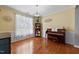 Cozy living room with hardwood floors, piano, and natural light, perfect for relaxation at 5240 Holly Ridge Farm Rd, Raleigh, NC 27616