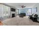 Bright living room with fireplace, carpet, and dual sofas under a ceiling fan at 5240 Holly Ridge Farm Rd, Raleigh, NC 27616