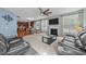 Open-concept living room features plush sofas, a fireplace, and adjacent kitchen at 5240 Holly Ridge Farm Rd, Raleigh, NC 27616