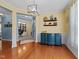 Elegant living room with hardwood floors, stylish lighting, and seamless flow to adjacent rooms at 5240 Holly Ridge Farm Rd, Raleigh, NC 27616