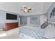 This airy main bedroom boasts a tray ceiling and an expansive layout and neutral carpet at 5240 Holly Ridge Farm Rd, Raleigh, NC 27616
