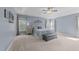 Airy main bedroom features neutral paint, large windows, tray ceiling and ceiling fan at 5240 Holly Ridge Farm Rd, Raleigh, NC 27616