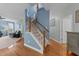 Bright staircase leading to the upper level with wood and carpet finishes at 5240 Holly Ridge Farm Rd, Raleigh, NC 27616
