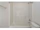 Bathroom features a bathtub with shower and a white surround at 5610 Picnic Rock Ln, Raleigh, NC 27613