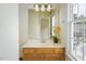 Bathroom showcasing a vanity with ample counter space and a large window for natural light at 5610 Picnic Rock Ln, Raleigh, NC 27613
