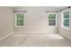 Spacious bedroom with neutral carpet, large windows, and ample natural light at 5610 Picnic Rock Ln, Raleigh, NC 27613