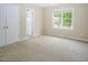Bedroom with neutral carpet, natural light from a large window, and ample closet space at 5610 Picnic Rock Ln, Raleigh, NC 27613