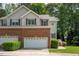 Charming two-story townhome with a brick front, attached garage, and well-manicured landscaping at 5610 Picnic Rock Ln, Raleigh, NC 27613