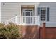 Charming front entrance with a well-maintained exterior, complemented by vibrant red roses and a brick foundation at 5610 Picnic Rock Ln, Raleigh, NC 27613