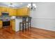 Open kitchen with wood floors, updated appliances, and a breakfast bar with seating at 5610 Picnic Rock Ln, Raleigh, NC 27613