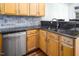 Close-up of the kitchen area showcasing granite countertops and stainless steel appliances at 5610 Picnic Rock Ln, Raleigh, NC 27613
