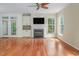 Cozy living room with hardwood floors, fireplace, built-in cabinets, and access to the backyard at 5610 Picnic Rock Ln, Raleigh, NC 27613