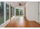 Inviting sunroom features wood-paneled ceiling, numerous windows, and access to the backyard at 5610 Picnic Rock Ln, Raleigh, NC 27613