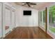 Light-filled sunroom with wood-paneled ceiling, multiple windows, and access to the backyard at 5610 Picnic Rock Ln, Raleigh, NC 27613