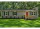 Charming home featuring gray siding, a bright red front door, and lush green lawn at 567 Howard Tant Rd, Zebulon, NC 27597