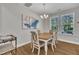 Dining room features a wooden table, cushioned chairs, chandelier, and natural light from nearby windows at 5701 Princess Curry Way, Raleigh, NC 27610