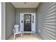Cozy front porch featuring a decorative door with a wreath and a rocking chair at 5701 Princess Curry Way, Raleigh, NC 27610