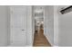 Hallway with natural wood floors and white trim, leading to the main living areas at 5701 Princess Curry Way, Raleigh, NC 27610