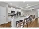 Modern kitchen with stainless steel appliances, granite countertops, and bar seating at 5701 Princess Curry Way, Raleigh, NC 27610