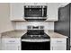 Modern kitchen features stainless steel appliances, granite countertops, white cabinets, and subway tile backsplash at 5701 Princess Curry Way, Raleigh, NC 27610