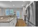 Bright kitchen features stainless steel appliances, granite countertops, and backyard access door at 5701 Princess Curry Way, Raleigh, NC 27610