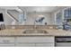 Kitchen sink with stainless steel faucet set in granite counter, with an open view to the living spaces at 5701 Princess Curry Way, Raleigh, NC 27610