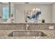 Close-up of stainless steel kitchen sink and granite countertop with dining area in background at 5701 Princess Curry Way, Raleigh, NC 27610