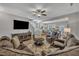 Spacious living room featuring comfortable seating, a ceiling fan, and open to the kitchen at 5701 Princess Curry Way, Raleigh, NC 27610