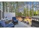 Cozy outdoor patio with grill, outdoor seating, and serene wooded surroundings at 5701 Princess Curry Way, Raleigh, NC 27610