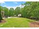Expansive backyard featuring lush green lawn, mature trees, and a charming pool area at 5803 Vintage Oak Ln, Raleigh, NC 27613