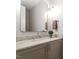 A well-lit bathroom featuring a marble countertop, decorative mirror, and stylish fixtures at 5803 Vintage Oak Ln, Raleigh, NC 27613