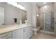 A luxurious bathroom featuring a walk-in shower and a long vanity at 5803 Vintage Oak Ln, Raleigh, NC 27613