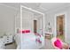 This bedroom is decorated with bright pink accents and a four-poster bed frame at 5803 Vintage Oak Ln, Raleigh, NC 27613