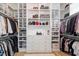 Spacious walk-in closet with custom shelving, drawers, and ample hanging space for clothes and shoes at 5803 Vintage Oak Ln, Raleigh, NC 27613