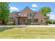 Stunning brick home featuring professionally landscaped front yard and a symmetrical front elevation at 5803 Vintage Oak Ln, Raleigh, NC 27613
