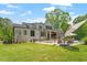 Beautiful backyard featuring lush green lawn, patio with fireplace, and inviting pool area at 5803 Vintage Oak Ln, Raleigh, NC 27613