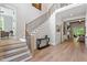 Spacious foyer with staircase, hardwood floors, modern railing, and neutral paint at 5803 Vintage Oak Ln, Raleigh, NC 27613