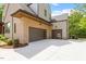 Attached two car garage with modern doors and exterior lighting at 5803 Vintage Oak Ln, Raleigh, NC 27613