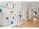 Inviting hallway with hardwood floors, built-in shelving, and natural light that provides charm and character at 5803 Vintage Oak Ln, Raleigh, NC 27613